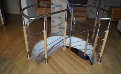 Drewniane schody kręte z metalowymi balustradami