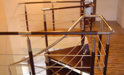 Drewniane schody kręte z metalowymi balustradami