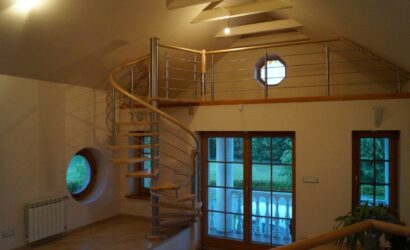 Drewniane schody kręte z metalowymi balustradami
