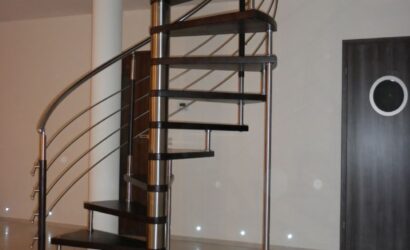 Drewniane schody kręte z metalowymi balustradami