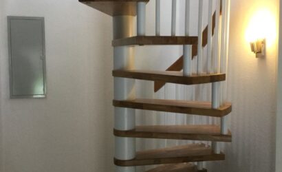 Drewniane schody kręte z metalowymi balustradami