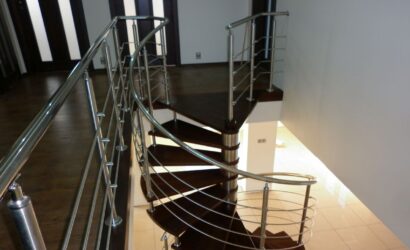 Drewniane schody kręte z metalowymi balustradami