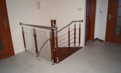 Drewniane schody kręte z metalowymi balustradami