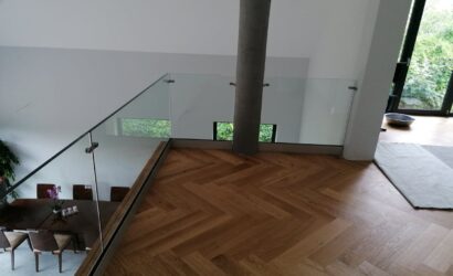 Schody dywanowe ze szklanymi balustradami
