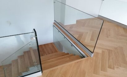 Schody dywanowe ze szklanymi balustradami